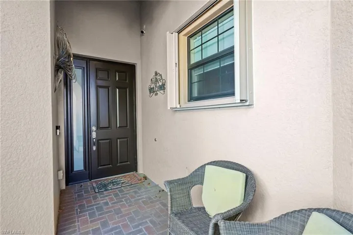 Doorway to property with stucco siding