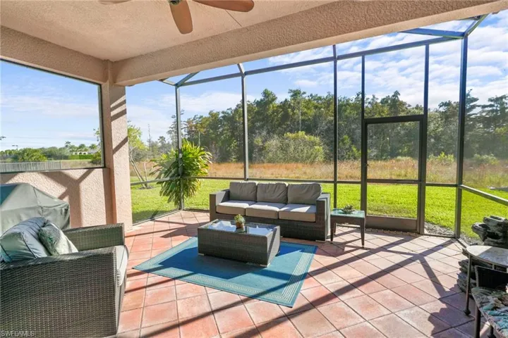 Sunroom with outdoor seating and a ceiling fan