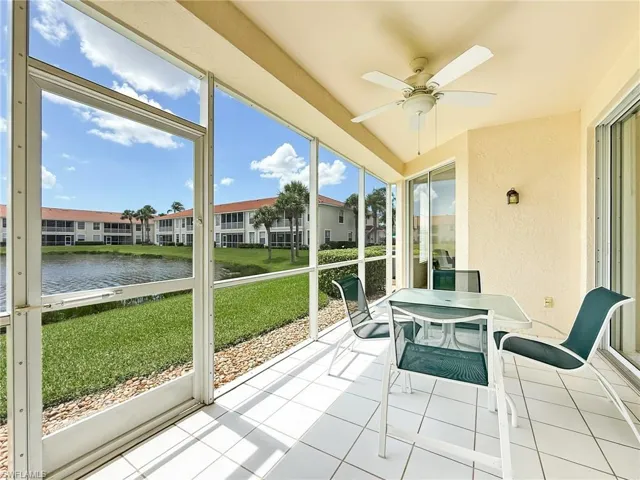 Sunroom / solarium featuring outdoor dining space, a water view, and a ceiling fan
