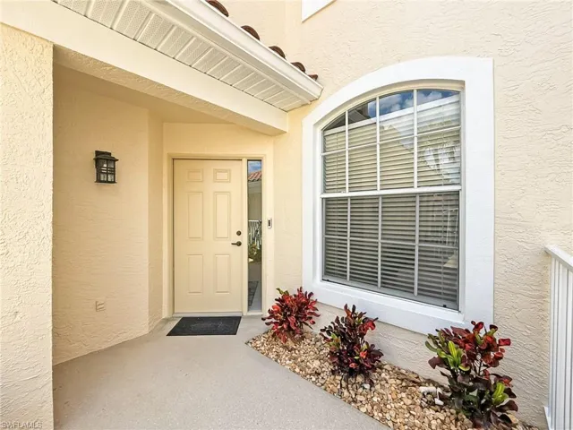 Property entrance with stucco siding