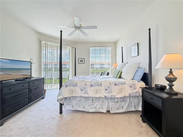 Bedroom with light carpet, access to exterior, and ceiling fan