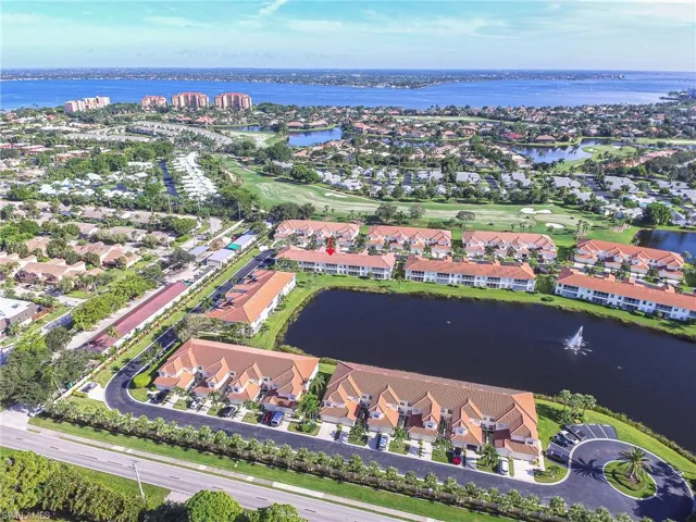 Birds eye view of property with a residential view and a water view