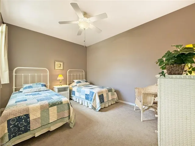 Bedroom with baseboards, a ceiling fan, and carpet