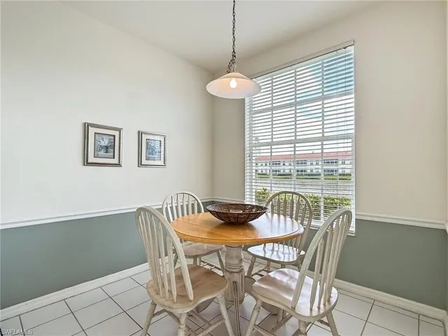 Dining room with baseboards and light tile patterned floors