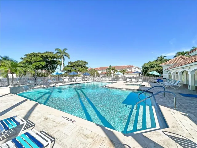 Pool with fence and a patio area