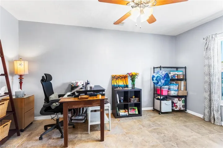 Third Bedroom used as a Home office with tile floors and ceiling fan