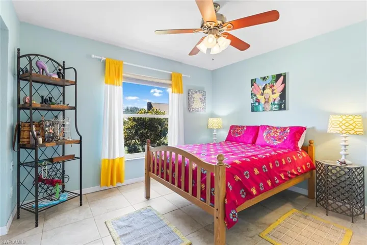 Bedroom featuring ceiling fan and light tile floors