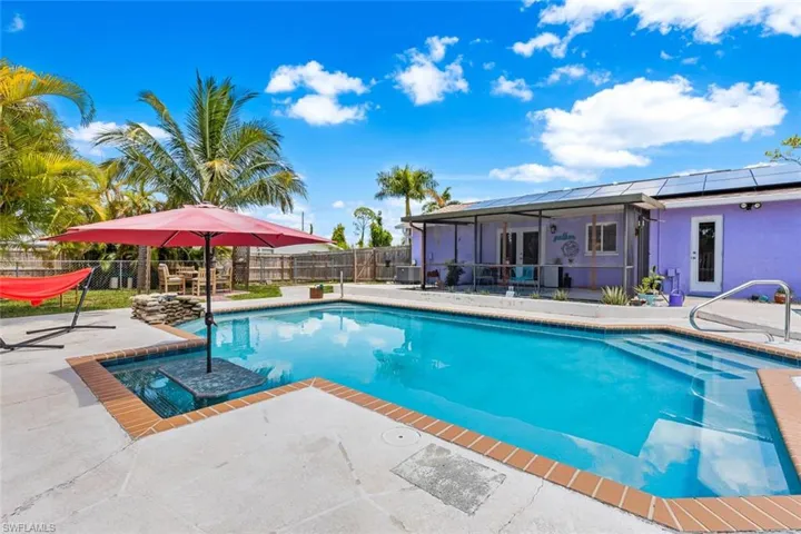 View of swimming pool with table and seating inside the pool