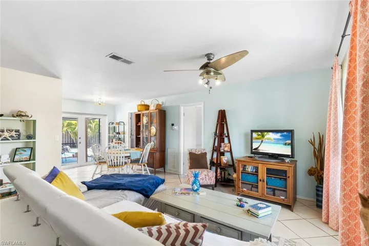 Living room / Dining room featuring ceiling fan and light tile floors