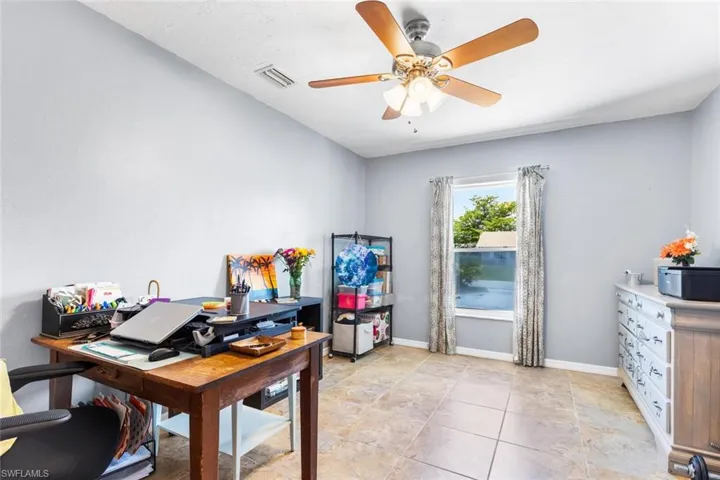 Third Bedroom used as a Home office with tile floors and ceiling fan