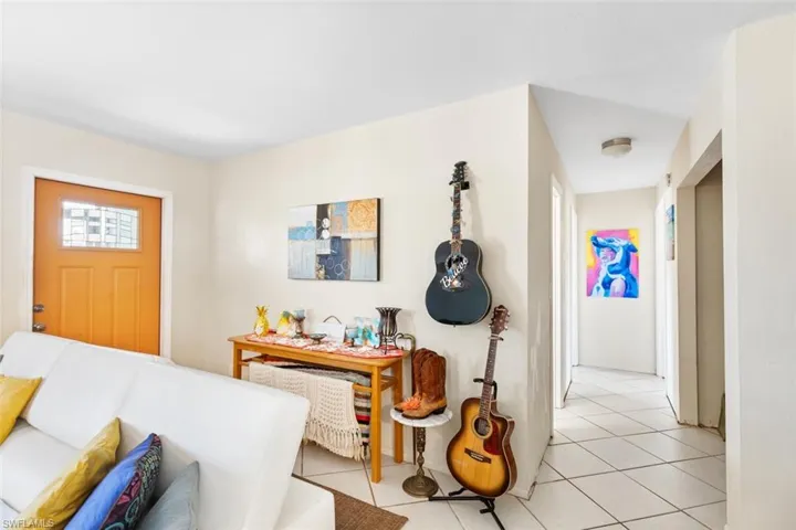 Living room Entrance featuring ceiling fan and light tile floors