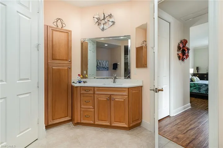 EAST-FACING EN-SUITE BATH WITH DUAL QUARTZ TOPPED VANITIES AND EXTRA STORAGE