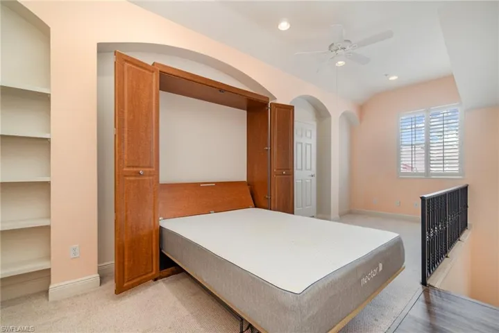 WALL BED EXTENDED.  PLANTATION SHUTTERS ON WEST-FACING WINDOW.  RECESSED LIGHTING.  ENTRANCE TO OWNER'S SUITE IS TO LEFT.  DOOR SHOWN AT MIDDLE REAR LEADS TO AIR HANDLER EQUIPMENT ROOM.