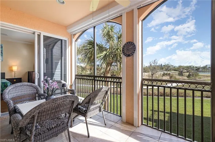 VIEW OF TILED AND SCREENED LANAI.  STORM SMART SCREENS.  ENTRANCE TO GUEST SUITE SHOWN.  VIEW IS OF BAY BEACH COMMONS.