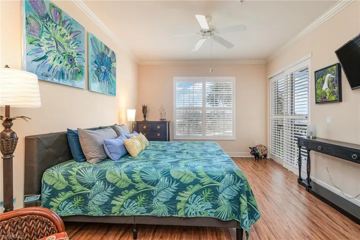 EAST FACING GUEST SUITE WITH DIRECT ACCESS TO SCREENED LANAI.  CROWN MOLDING.  PLANTATION SHUTTERS.  WOOD-LOOK LAMINATE FLOORING.