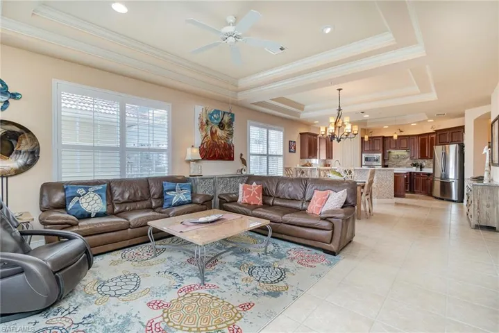 VIEW OF BIG OPEN MAIN FLOOR LIVING SPACE.  COFFERED CEILINGS.  PLANTATION SHUTTERS.  ENTRANCE TO EAST-FACING GUEST SUITE IS TO RIGHT.