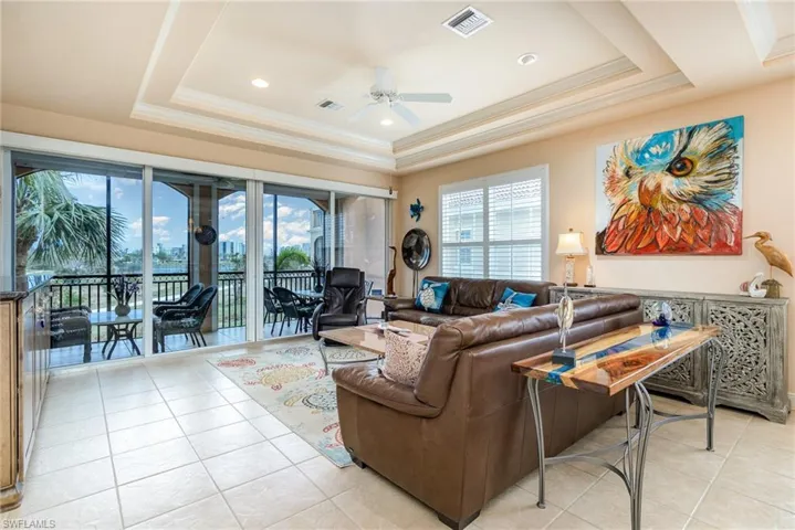 SPACIOUS LIVING AREA SHOWING SCREENED LANAI (WITH STORM SMART SCREENS).  4-PANEL SLIDING DOORS.  DOUBLE-COFFERED CEILING.  RECESSED LIGHTING.  PLANTATION SHUTTERS.