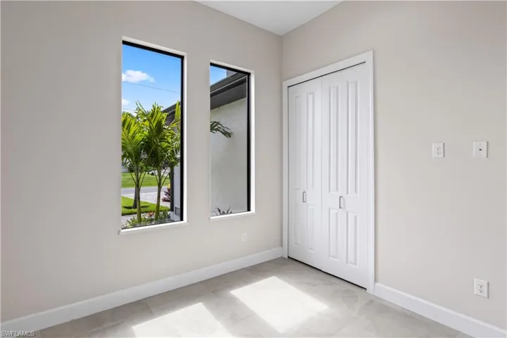 Unfurnished bedroom with light tile patterned flooring and a closet