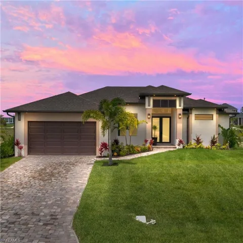 Prairie-style home featuring a garage and a yard