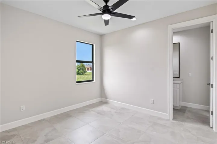 Tiled empty room with ceiling fan