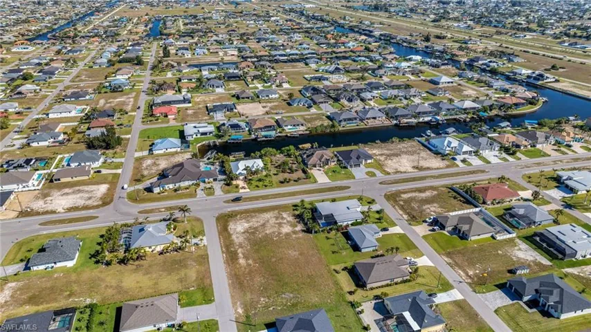 Birds eye view of property with a residential view and a water view