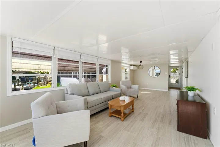 Living area featuring baseboards and wood finish floors