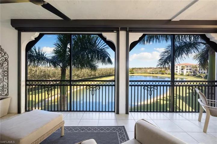 Sunroom / solarium featuring a water view
