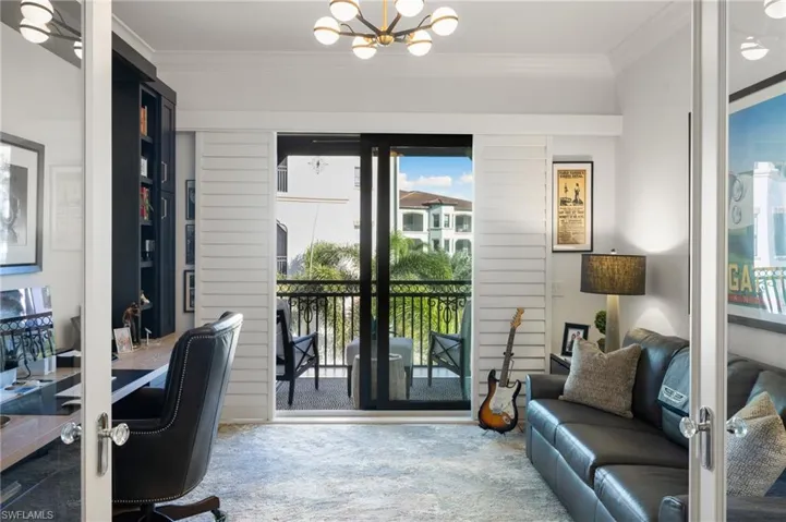 Office space featuring ornamental molding, an inviting chandelier, and french doors