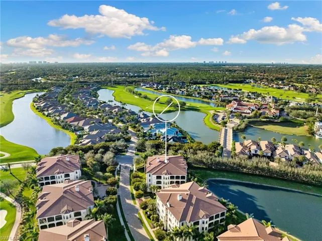Birds eye view of property with a water view