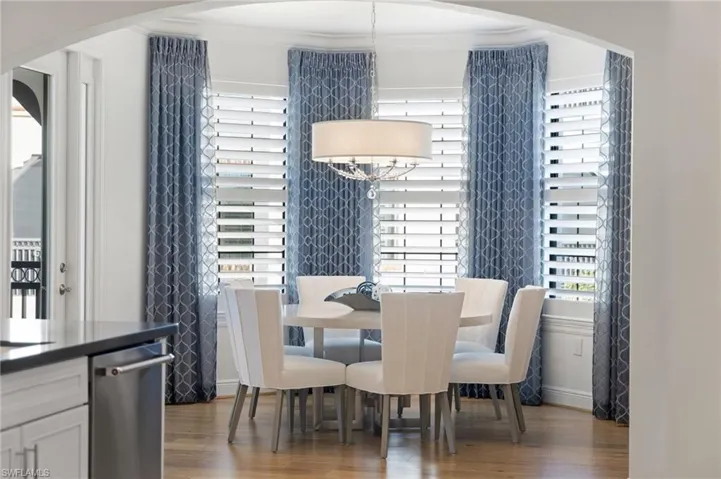 Dining space featuring crown molding and wood-type flooring