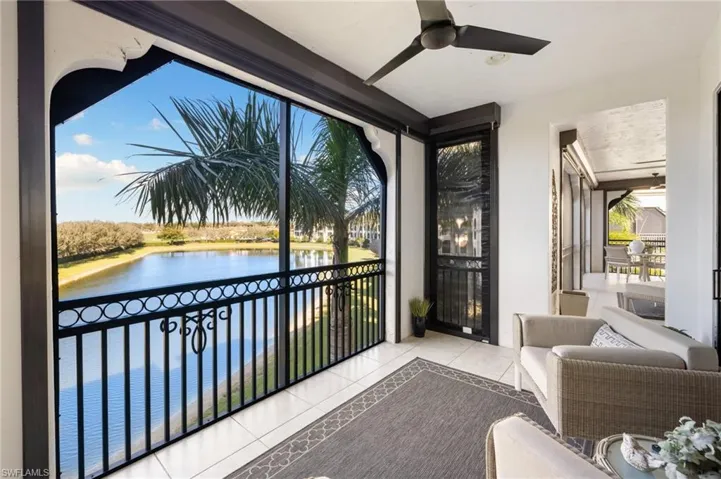 Sunroom / solarium featuring a water view and ceiling fan