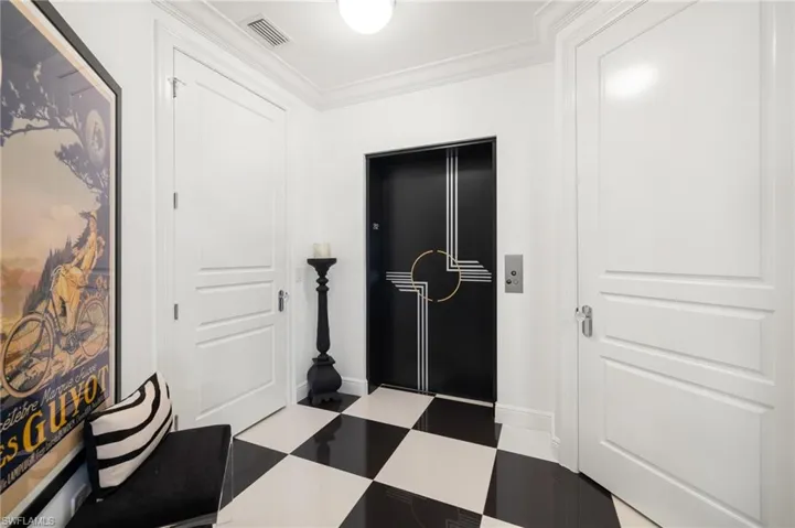 Hallway with crown molding and elevator