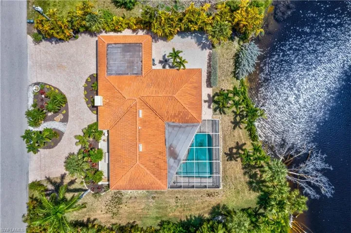 Aerial perspective highlighting the home’s impressive footprint, outdoor living areas, and serene canal views.