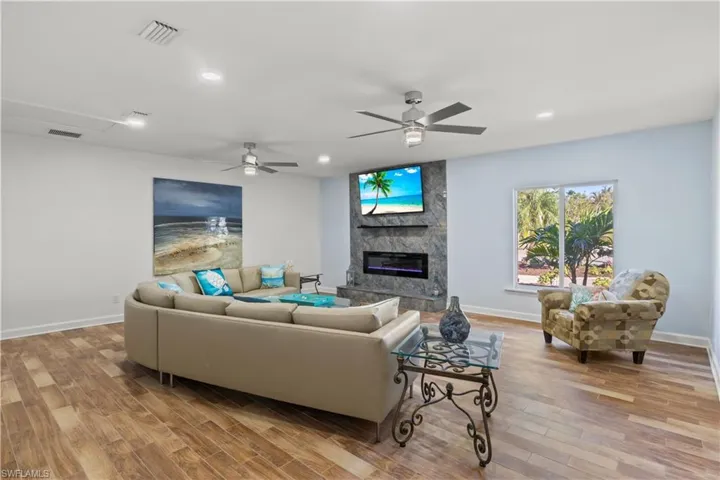 Impressive 21x21 recreation room with fireplace—ideal for a game room or home theater.