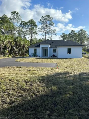 Back of house with a yard
