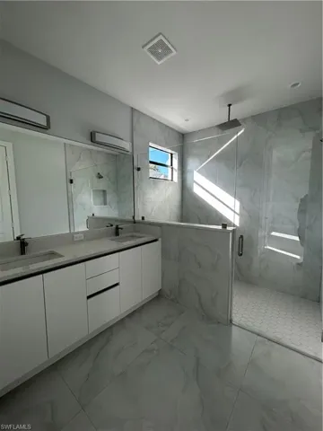 Bathroom featuring vanity and a shower with shower door