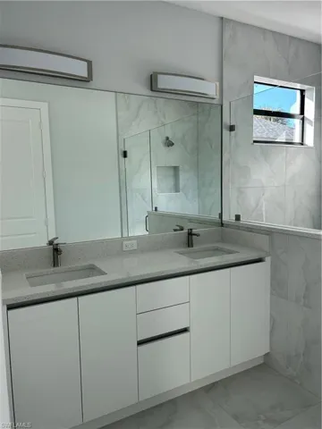 Bathroom with vanity and a shower with shower door