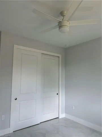 Unfurnished bedroom with a closet and ceiling fan