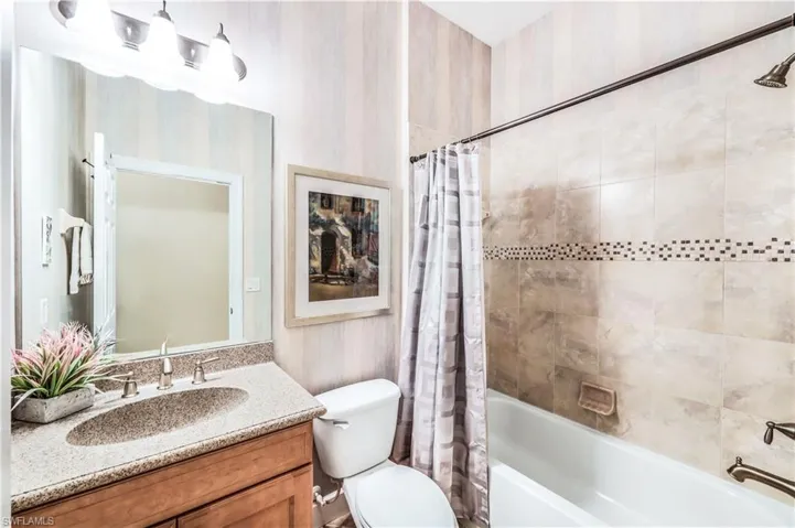 4th Full bathroom with vanity, toilet, and shower / tub combo is located just outside the den/office/5th bedroom