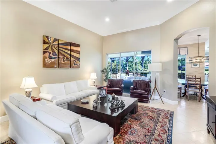 One of 2 living areas in the fine home. Acess to your covered lanai and pool deck.
