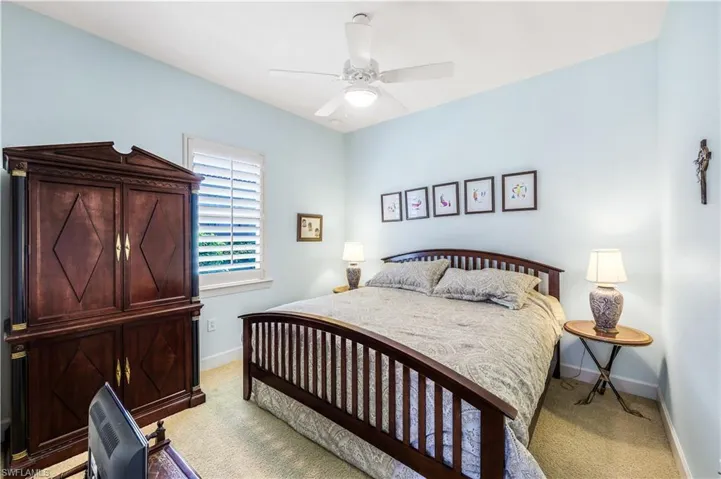 4th Bedroom with ceiling fan and light colored carpet.