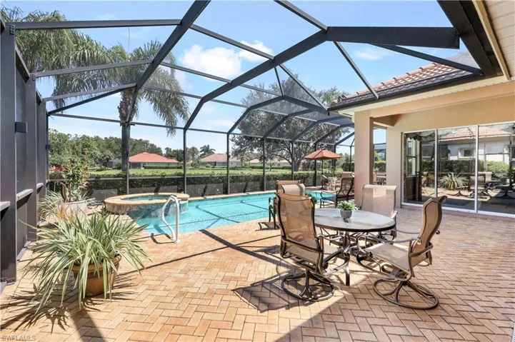 View of swimming pool featuring an in ground hot tub, a patio, and a lanai, all overelook the lake!