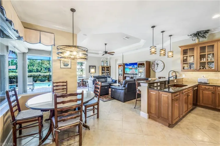 Breakfast nook is right off of the kitchen. Stunning chandelier. Views of the lake.