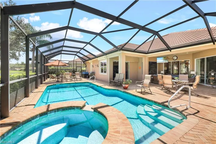 View of pool featuring an in ground hot tub, a patio, and a lanai