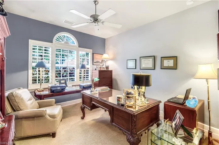 This can easily serve as the 5th bedroom. It is being used as an office. Lots of natural light spills into this home and features a ceiling fan and carpet flooring, custom plantation shutters.