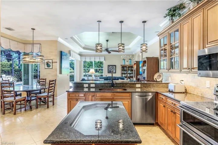 Kitchen with a center island, appliances with stainless steel finishes. New copper sink.