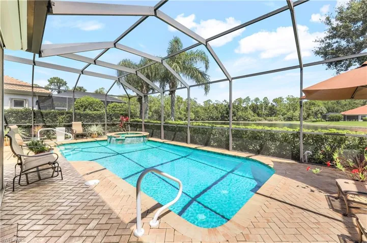 View of pool with a patio area, an in ground hot tub, and a lanai
