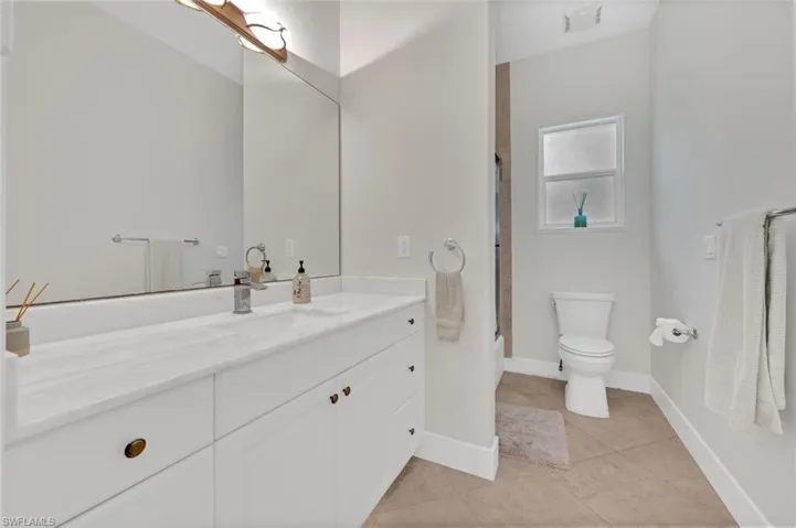 Bathroom with tile patterned floors, toilet, and vanity