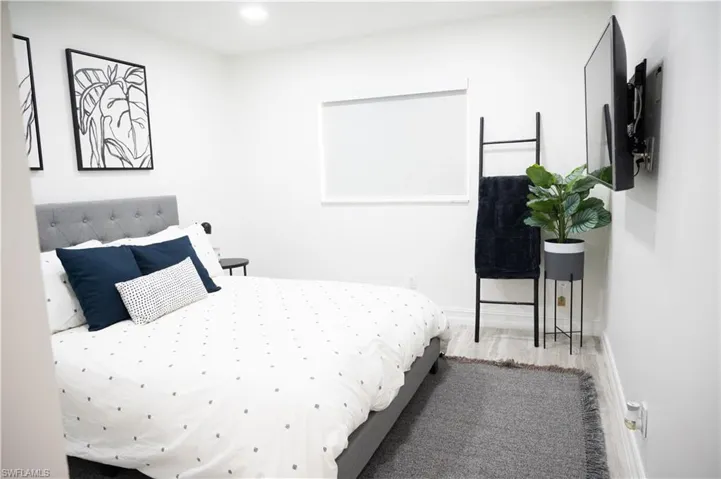 Bedroom featuring wood finished floors and recessed lighting