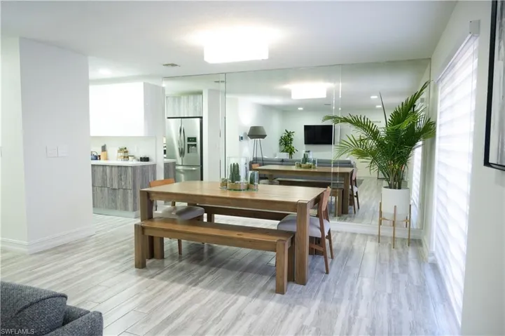 Dining room featuring light wood-style flooring and baseboards